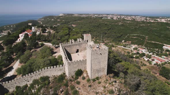 Aerial orbiting over Sesimbra Castle Watching tower, Scenery viewpoint  - Portugal