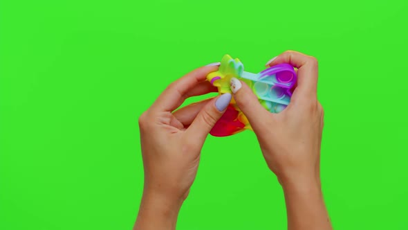 Girl Hands Squeezing Presses Colorful Antistress Touch Screen Push Pop It Toy Game on Chroma Key