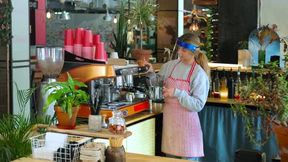 Barista in Coffee Shop Making Takeaway Order