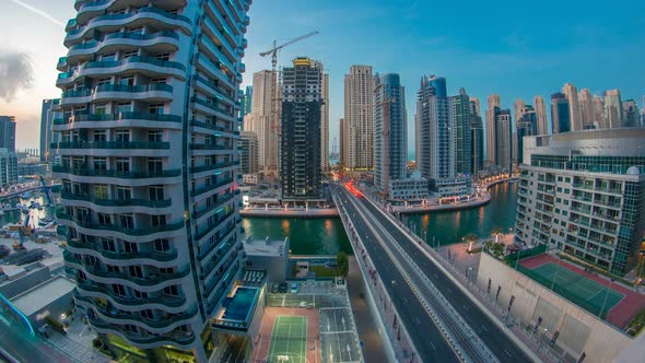 An Aerial View of Dubai Marina Towers in Dubai Day to Night Timelapse