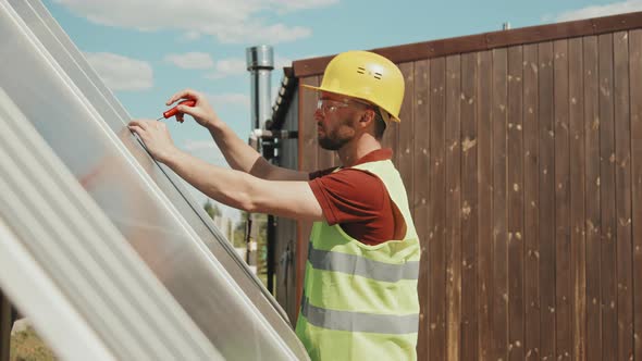 Male Engineer Installing Solar Cells