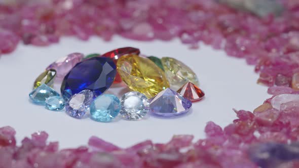 Close Up Colorful Diamonds Are Placed In Raw Pink Gemstones