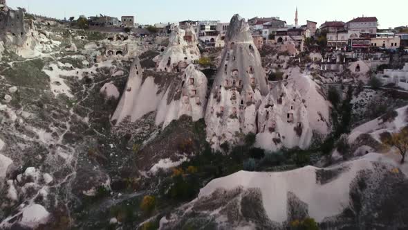 Aerial Drone View of Uchisar Cave Town at Summer Evening with Ancient Cave Houses of Goreme