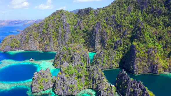 Tropical lagoon with azure water and high mountain limestone formation