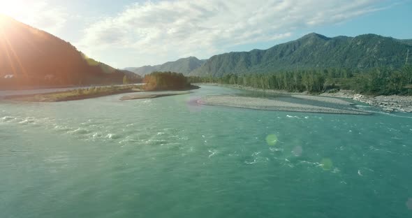 Low Altitude Flight Over Fresh Fast Mountain River with Rocks at Sunny Summer Morning