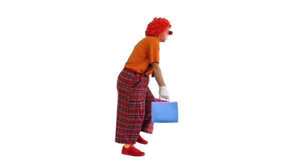 Funny Clown with Heavy Shopping Bags Walking on White Background