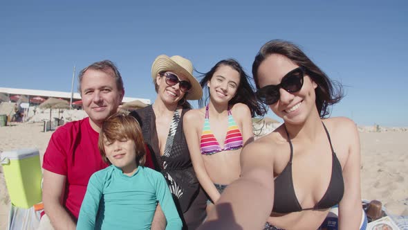 POV of Female Teenager Taking Selfie with Family on Sea Shore