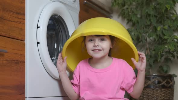 Washing clothes. A child with a basin on head.