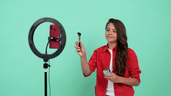 Smiling Child Influencer Advertising Beauty Product of Powder Brush Use Selfie Led Blogging