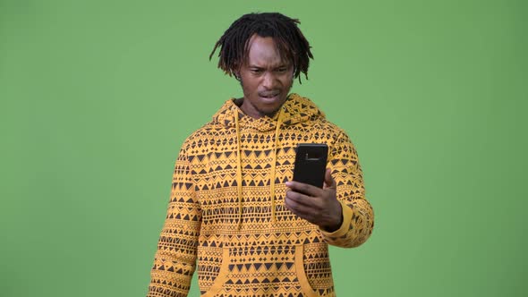 Young Stressed African Man Using Phone