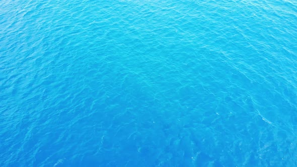 Camera flies over the blur ocean waves to  the clean horizon 