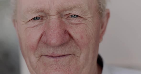 Light Looking and Smiling Into Camera of Senior Man Indoor