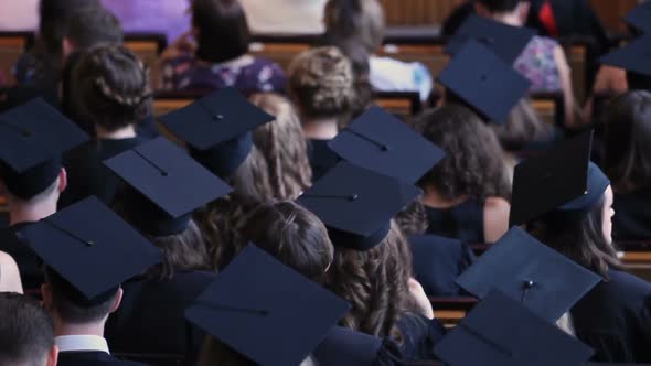 Excited Marketing Students Listening to Speech at Diploma Awarding Ceremony