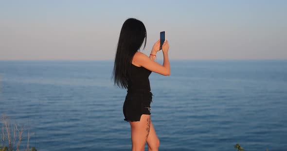 Woman Photographing Sea View By the Phone