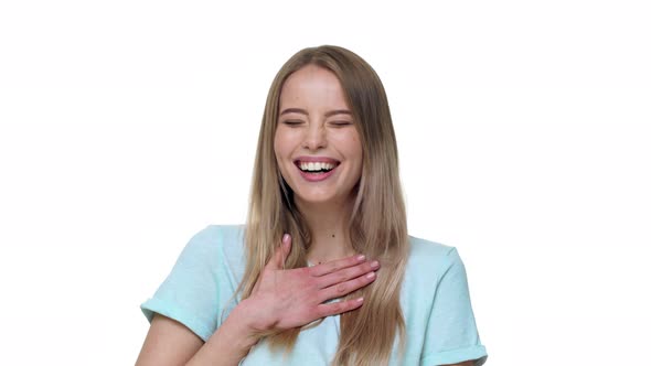 Portrait of Optimistic Woman 20s Wearing Basic Tshirt Bursting in Laughter Isolated Over White