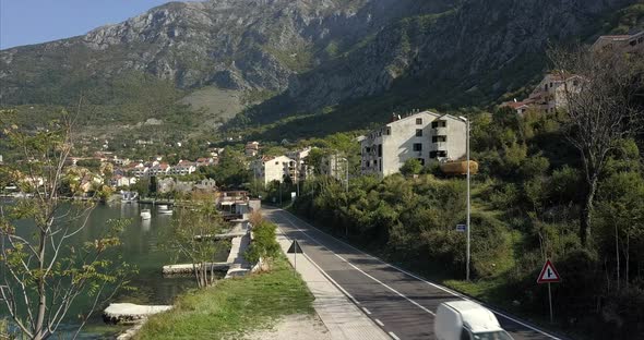 Risan in Montenegro, aerial shot of the main road around the Bay of Kotor, rising up to a wide shot