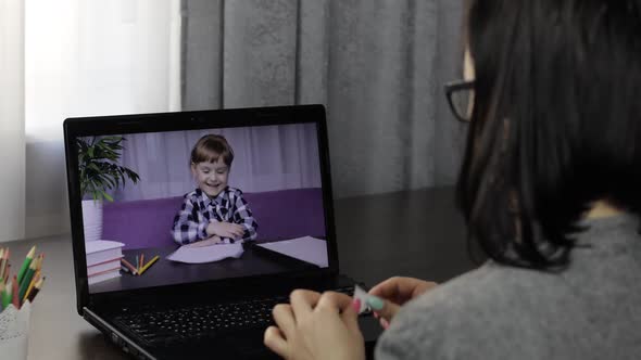 Woman Teacher Making Video Call on Laptop with Little Pupil. Distance Education