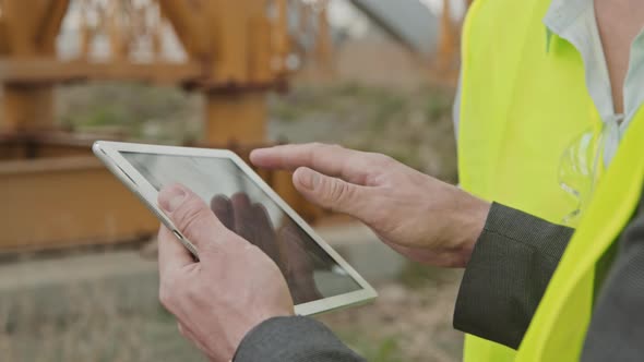 Close Up of Unrecognizable Site Supervisor with Tablet