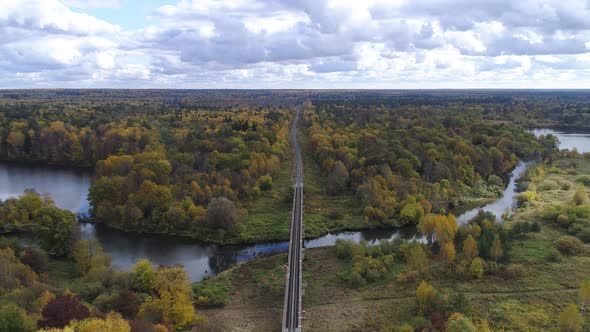 Flying over a railway in the autumn forest
