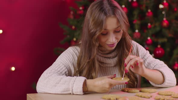 Pretty Long-haired Smiling Girl Icing Heart-shaped Christmas Gingerbread Cookie