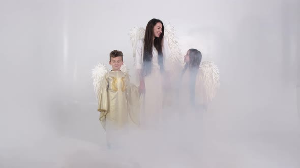 Family with Angel Wings on a White Background They are in Smoke