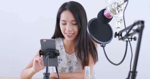 Young Woman having live stream on mobile phone 