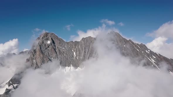 Aerial approach to the mountain range of the Schreckhorn peak in the Swiss alps in the Grindelwald r