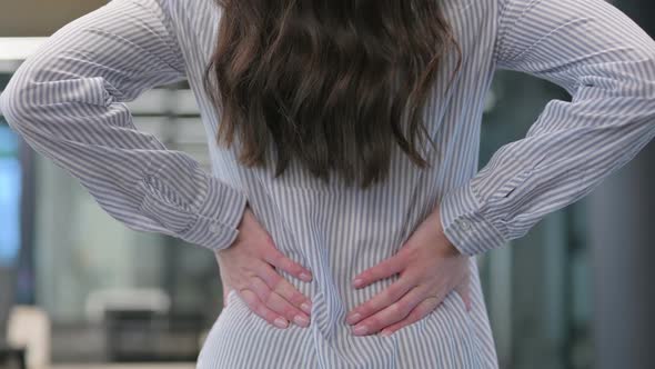 Close up of Woman Holding Back while having Pain