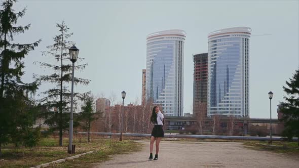 Happy Asian Girl Jumping on Road in Short School Uniform