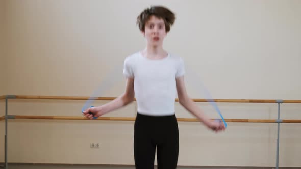 Boys Teenagers Jumping with Skipping Rope Doing Exercise in Ballet Dance School