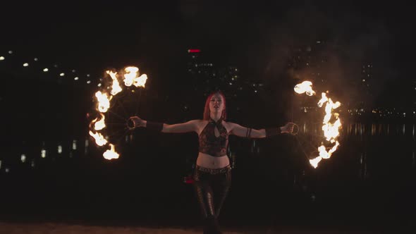 Stylish Firegirl Spinning Fans During Fireshow