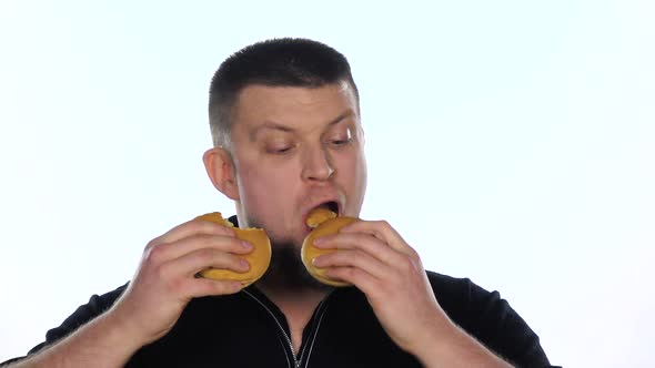 Young Man Eats a Cheeseburgers, White,Slow Motion