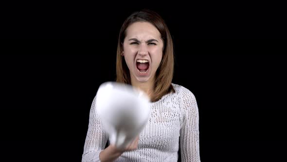 A Young Woman Takes Off the Mask and Shows Emotions of Anger on Her Face. Woman Screaming While