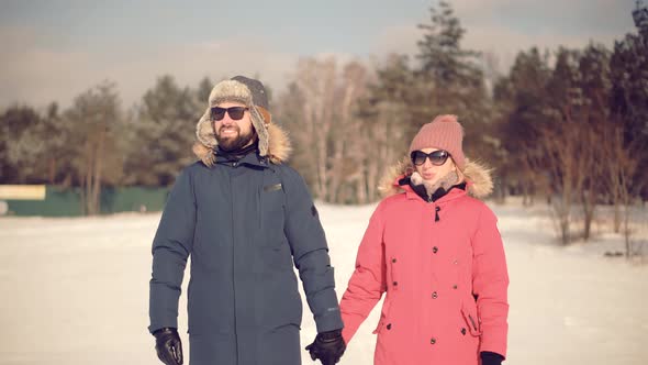 Couple Walking And Enjoying Winter. Freezing Day On Holiday Vacation Trip. Loving Family Traveling.