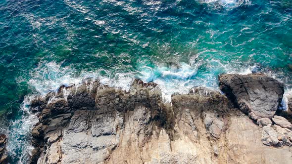 Rocky Seashore and Waves Running Along It