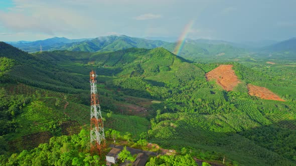 Aerial view over telecommunication towers on green mountain