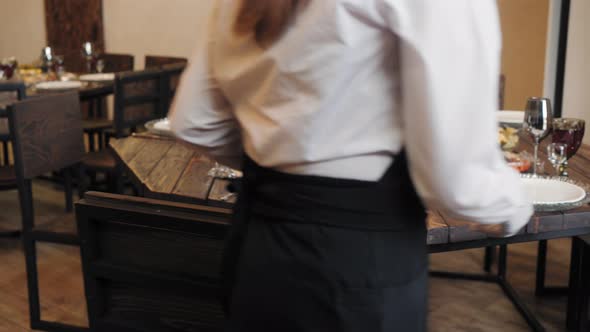 Waiter Serving Celebrate Buffet Table in Restaurant