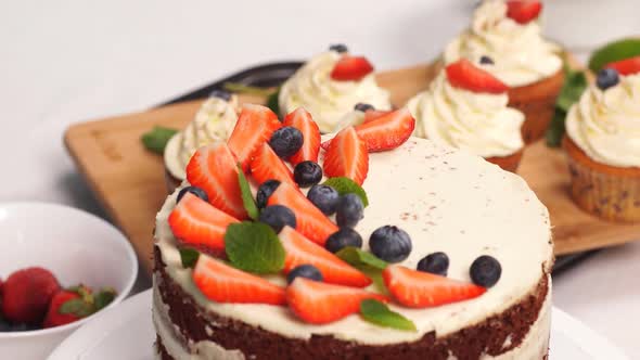 Confectioner Woman Is Decorating Delicious Cake in Studio