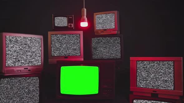 Stacked Retro TVs Turning On Green Screens