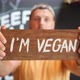 Young Bearded Man Holding Wooden I Am Vegan Sign - VideoHive Item for Sale