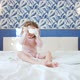 Funny Baby Girl in a Pink Dress and a Headband with Bunny Ears is Jumping on the King Size Bed in - VideoHive Item for Sale