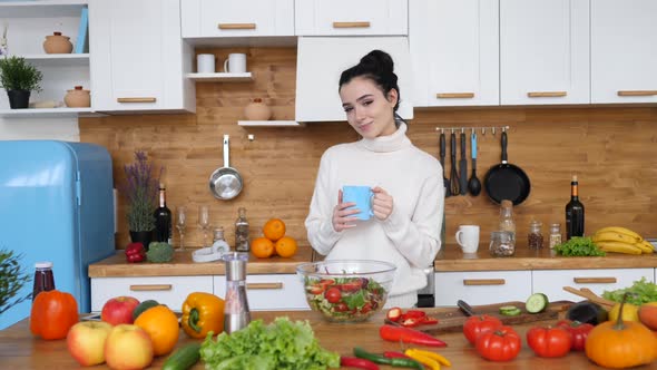 Young Brunette Woman Drinking A Cup Of Coffee In The Morning