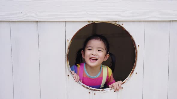 4K Portrait of Little Asian girl playing at outdoor playground in the park