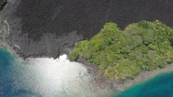 Aerial: flying over Banda Islands active volcano Gunung Api lava flow Indonesia 