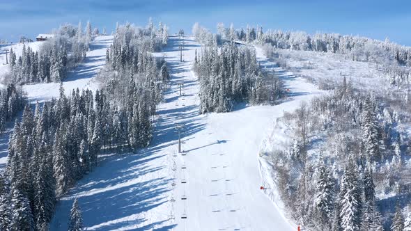 Aerial View of Ski Resort with People Snowboarding Down the Hill