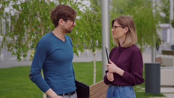 Young man and woman talk sadly about a failure.