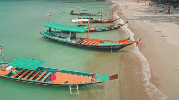 Aerial View Slow Flight Over Longtail Boats on Turquoise Sea