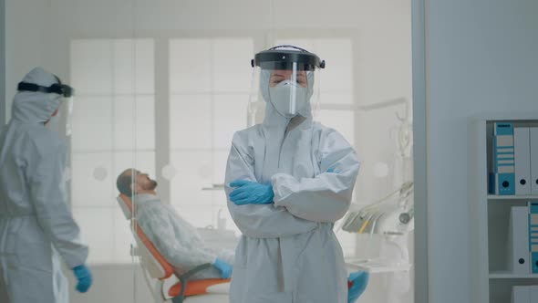 Portrait of Dentist Standing in Hazmat Suit for Virus Protection