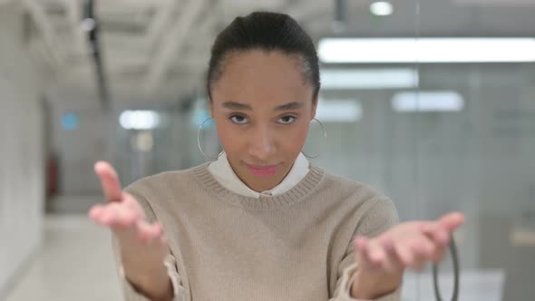 African Woman Pointing at the Camera and Inviting