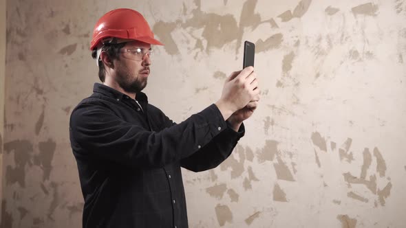 Designer Is Taking Photo of Flat Under Construction By Smartphone